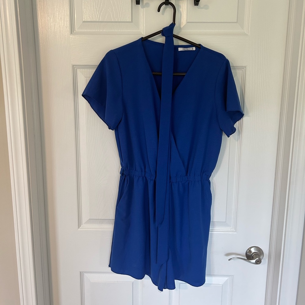 Royal blue romper with a tie belt.